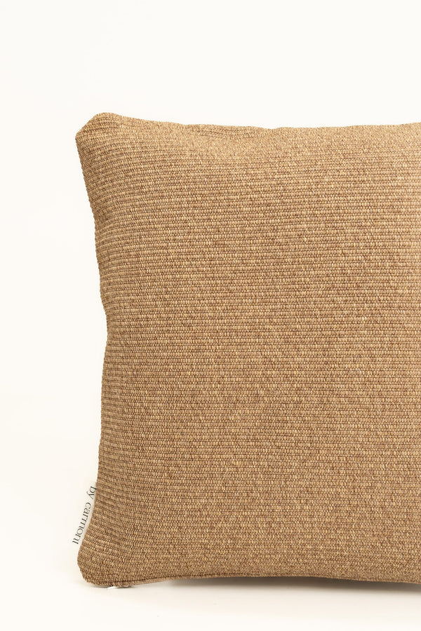 By Carmont Wren cushion cover in Natural, corner close-up showing the woven texture and brand label
