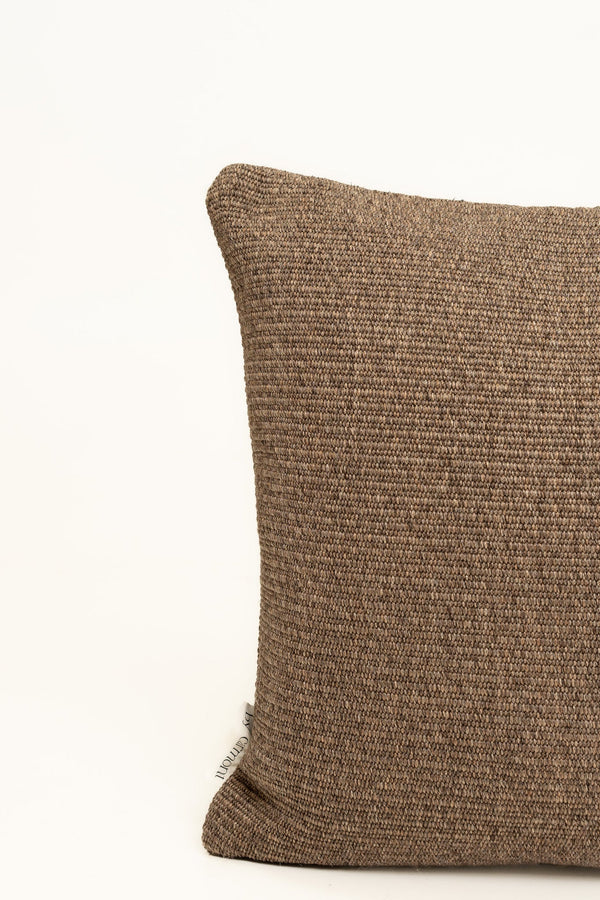 By Carmont Wren cushion cover in Topaz, corner close-up showing the woven texture and brand label