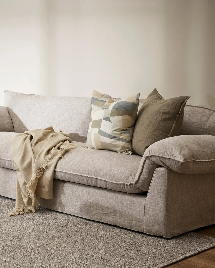 A contemporary living room featuring the Baya linen cushion in colour Greige