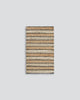 A full image of a striped doormat in different tones of natural jute, handwoven and designed by Baya. 
