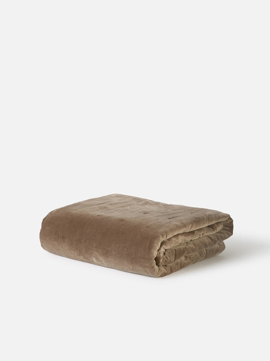 Città Cotton Velvet Quilt in Doe, a warm taupe quilt folded on a plain background