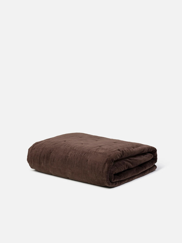 Città Cotton Velvet Quilt in Henna, a rich chocolate brown quilt folded on a plain background