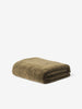 Città Cotton Velvet Quilt in Ivy, a deep mossy green quilt folded on a plain background