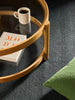 Città Joni Wool Mat in Baltic/Pine, styled in a living space beneath a round coffee table.