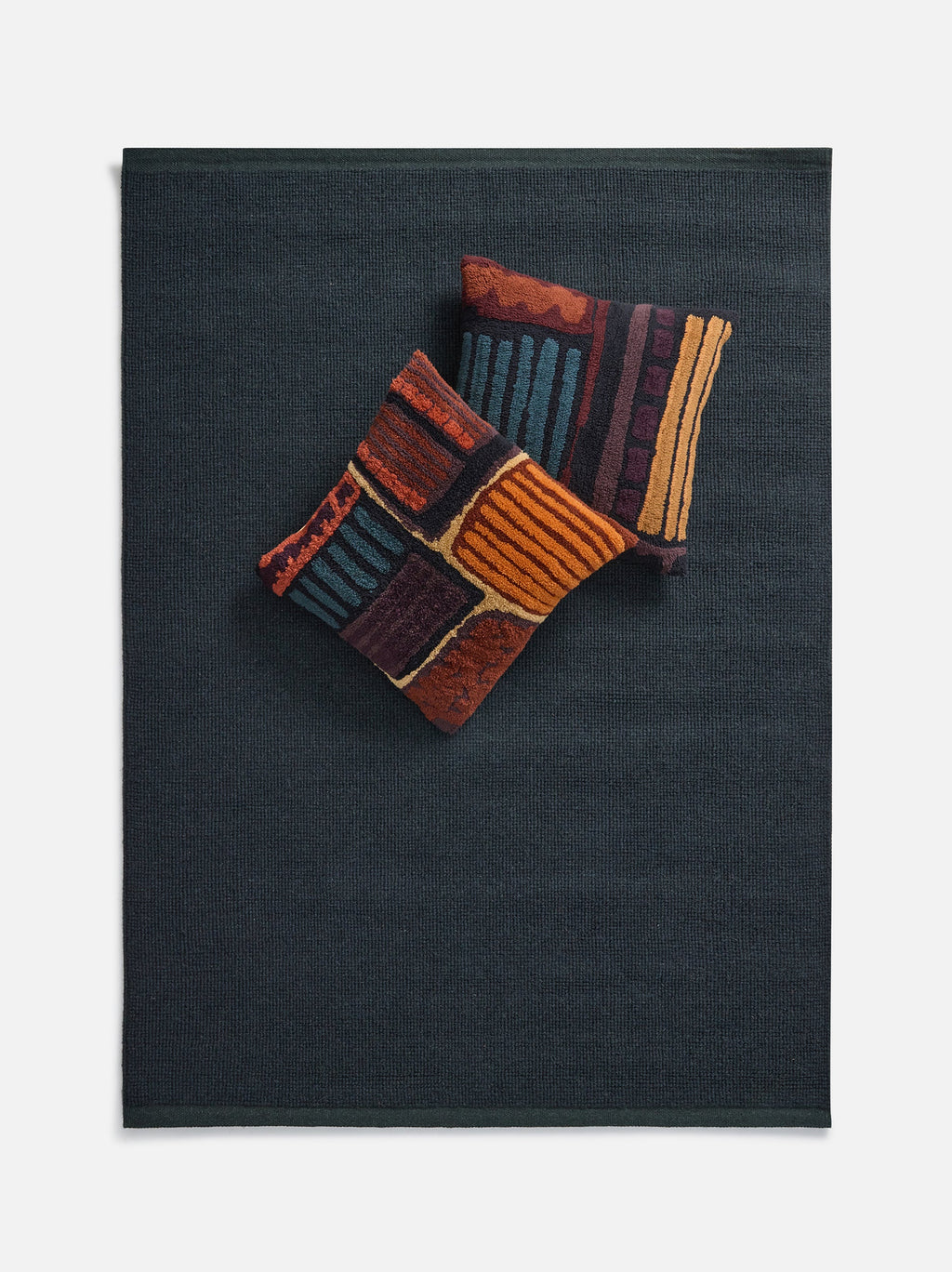 Città Joni Wool Mat in Baltic/Pine, overhead view styled in a living space.