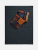 Città Joni Wool Mat in Baltic/Pine, overhead view styled in a living space.