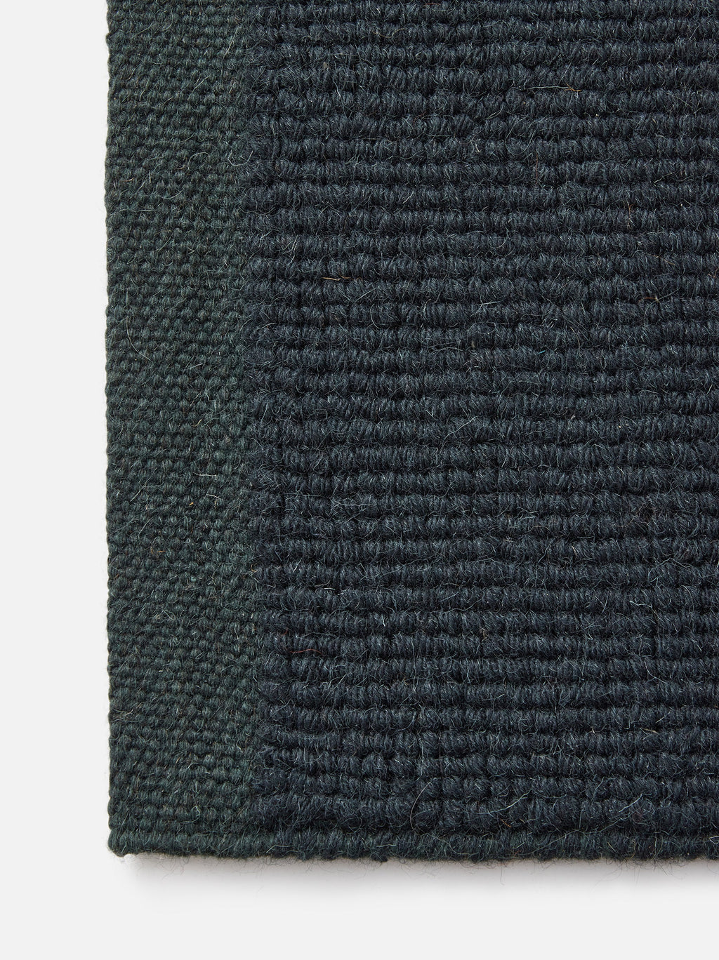 Città Joni Wool Mat in Baltic/Pine, close view of the popcorn-style woven texture.
