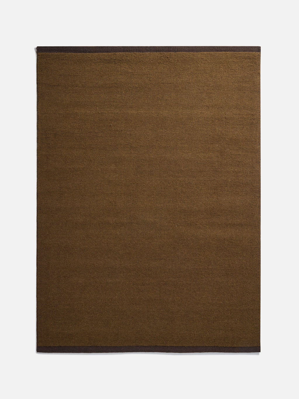 Città Joni Wool Mat in Kelp/Umber, flat lay showing the olive-brown body with dark brown trim at each end.