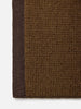 Città Joni Wool Mat in Kelp/Umber, close-up of the flat-woven texture and trim edge.