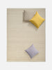 Città Joni Wool Mat in Oatmeal, overhead view styled in a living space.