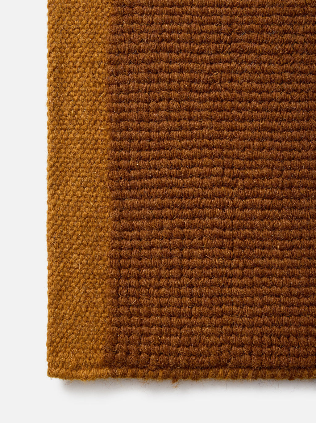 Città Joni Wool Mat in Orange Peel/Saffron, close view of the popcorn-style woven texture.