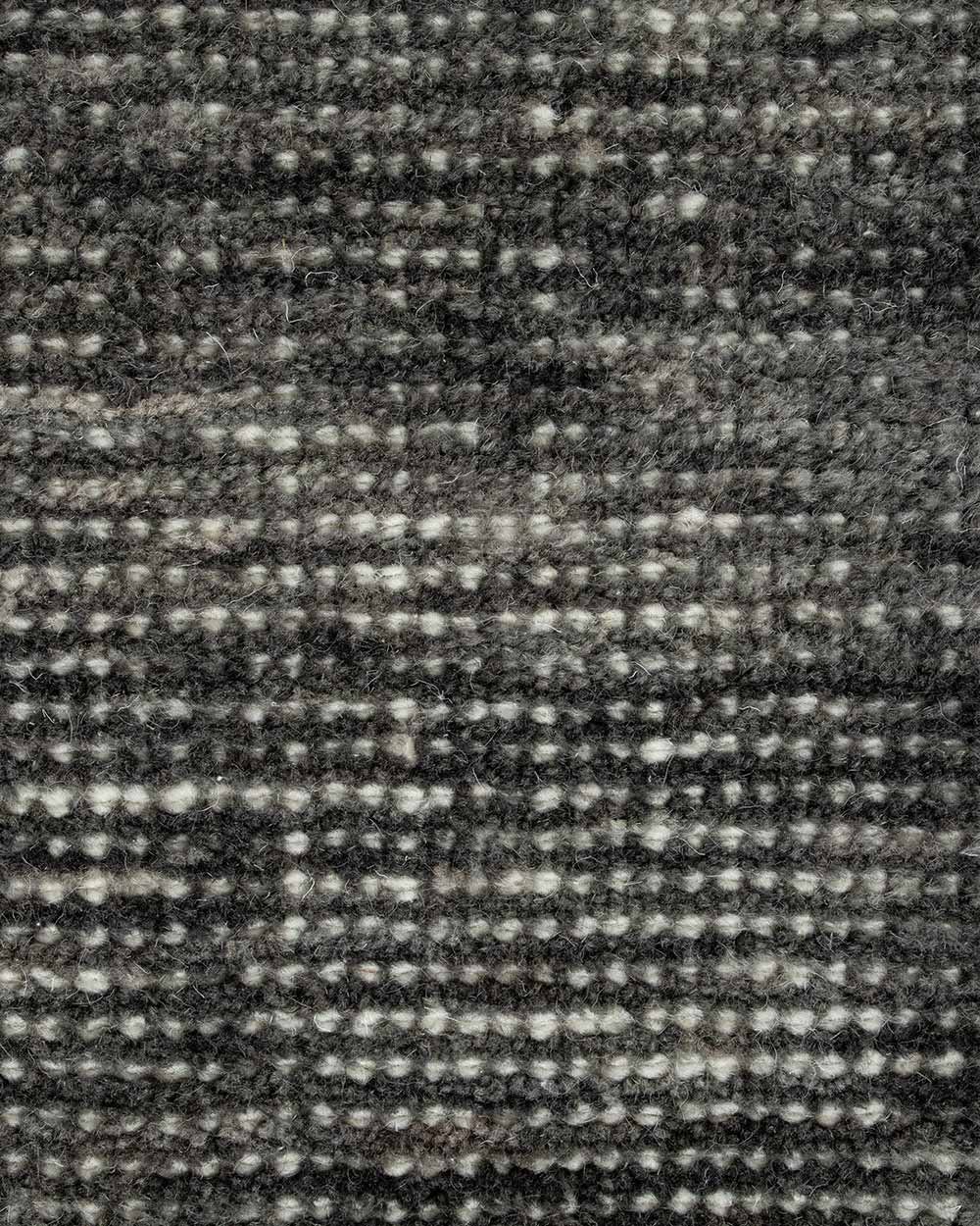 A close up image of a handloomed charcoal toned floor rug in 100% New Zealand Wool by Baya