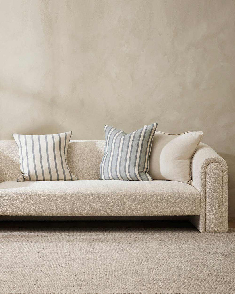 Baya cushions arranged on a couch in a light, contemporary home