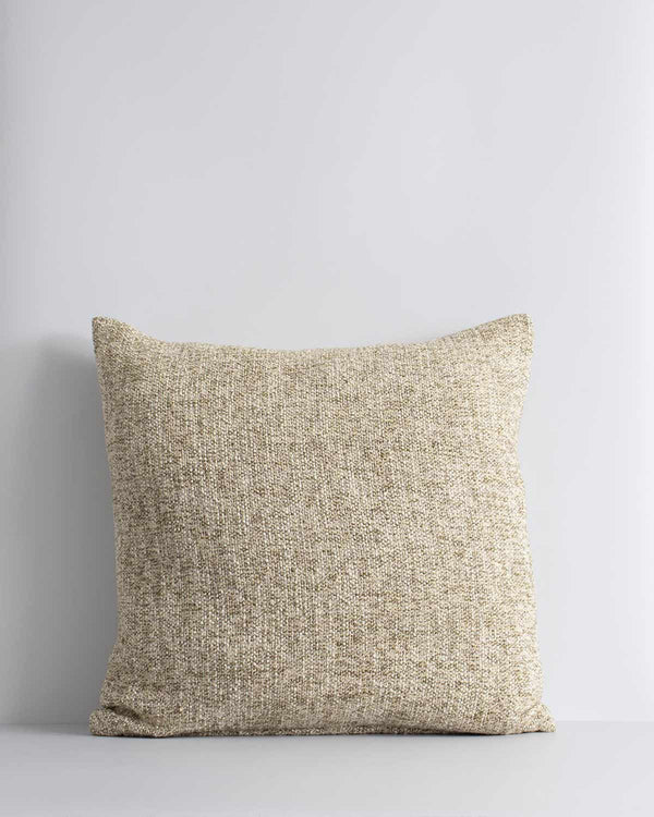 A textural woven cushion in shades of creamy oat and ercu, by Baya