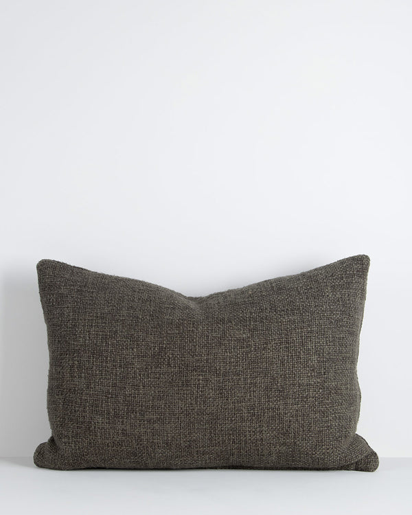 A textural lumbar cushion with a soft, large-thread weave in shades of deep green. By Baya