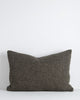 A textural lumbar cushion with a soft, large-thread weave in shades of deep green. By Baya