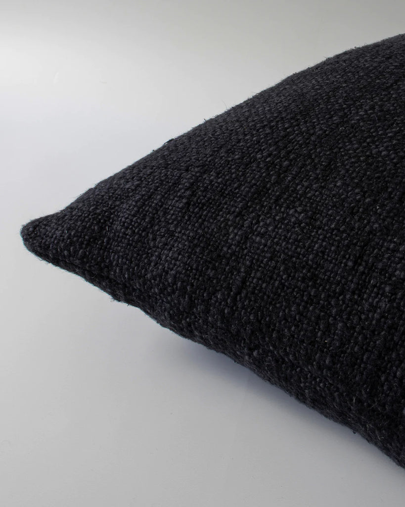 Close upo of the textural detail and edge of the Baya cyprian cushion in black