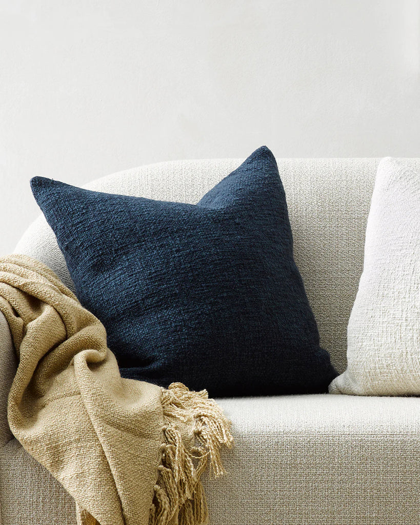 The Baya Cyprian textural weave cushion on a contrast cream couch 