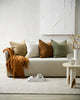 Natural, earthy toned cushions in a slubby textural weave, on a creamy white couch