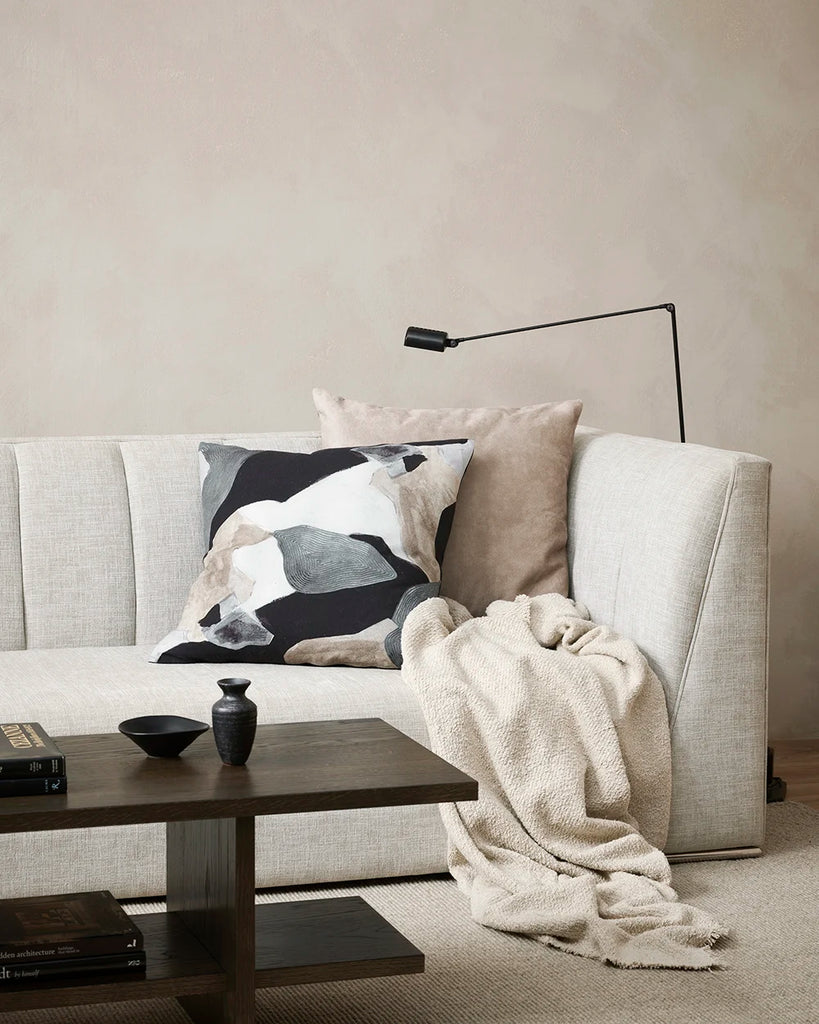 The Aalto designer cushion featuriing grey, black, brown and white tones, seen on a couch in a contemporary nz home