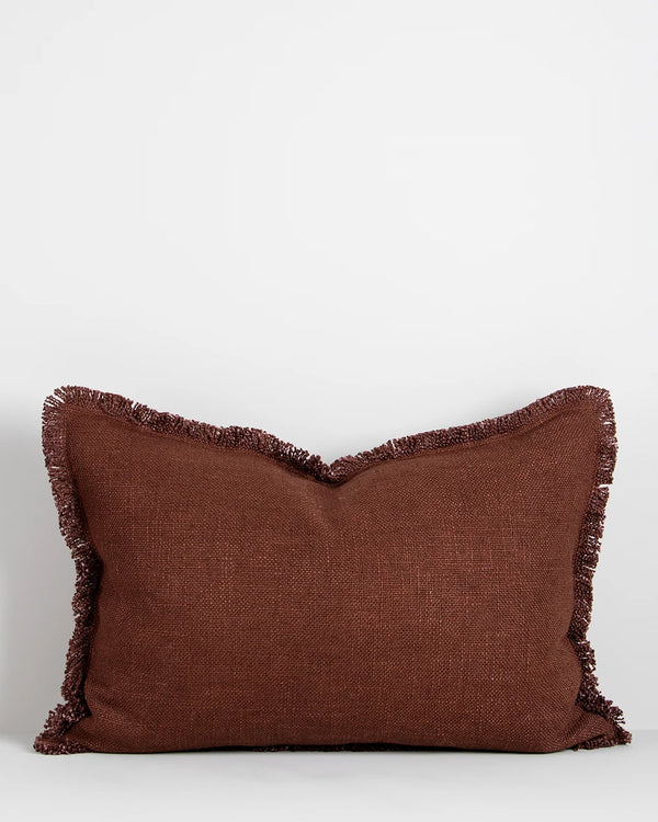 A rich red-brown lumbar cushion with fringe detail by Baya nz