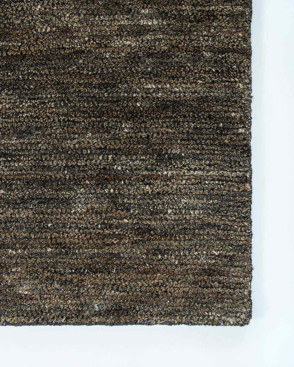 A corner image of the Fairbanks floor rug by Baya, handwoven and effortlessly chic. 