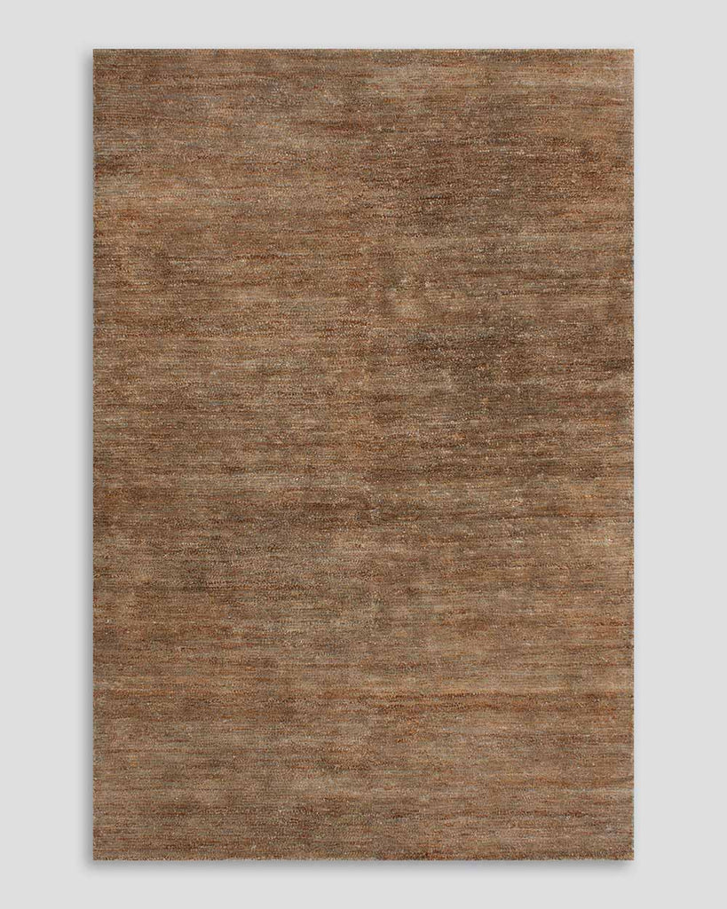 A full image of the Fairbanks floor rug in shade Sand, a deliciously warm toned brown handwoven piece in bamboo silk and jute. 