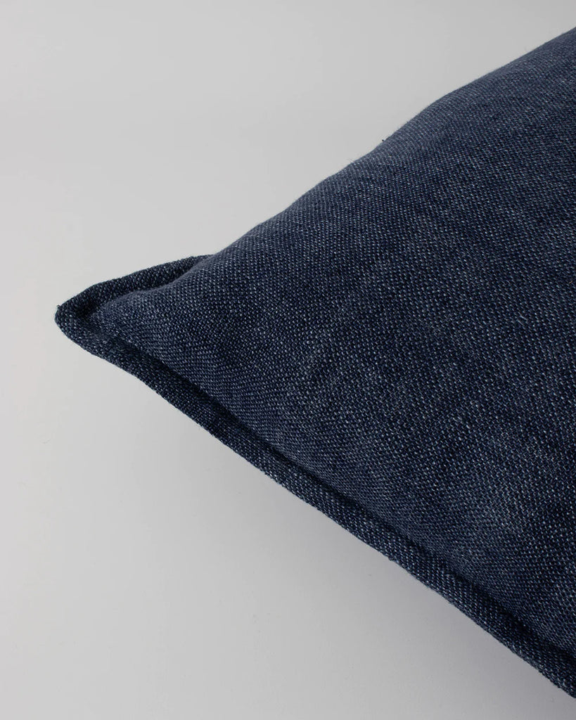 Close up of the textural weave and flange edge detail on the Baya Flaxmill linen cushion in colour blue ink