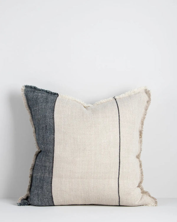 A natural linen cushion with designer stripe and fringed edge detail