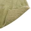 Corner image of a soft leaf-green handloomed woolen rug by Soren Liv. The edges are fringed with wool in a creamy ivory and flipped up to reveal the underside.