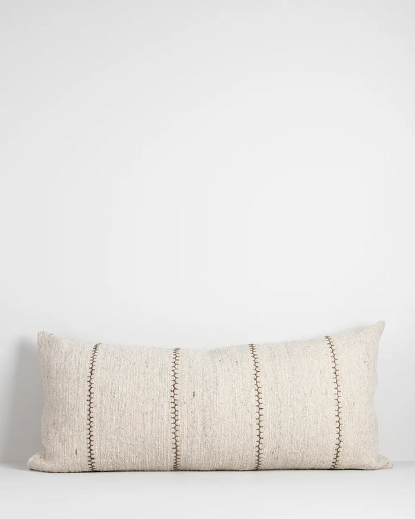 An extra-long lumbar, textural cotton cushion featuring a delicate Cretan-stitch is embroidered in khaki over a natural, ecru-toned base.