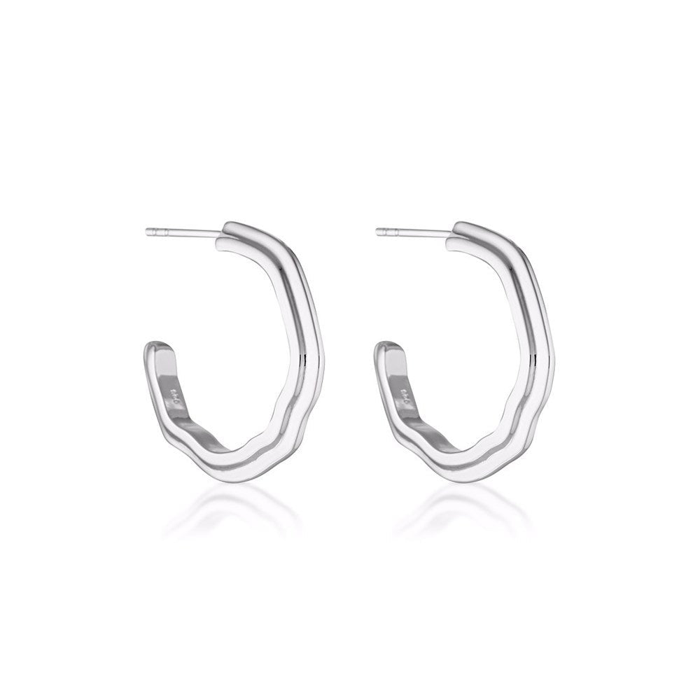 Two hoop earrings in sterling silver with chunky details by Linda Tahija. 