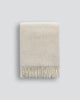 The Baya wool throw blanket 'Littano' in coloour cream oatmeal - folded with fringe showing