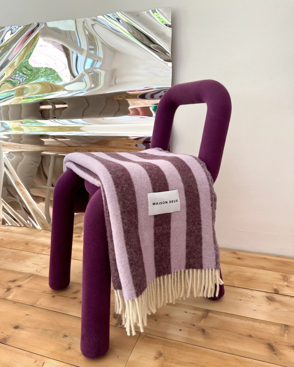 Maison Deux Candy Wrap wool throw in Lilac Aubergine, styled in a room setting.
