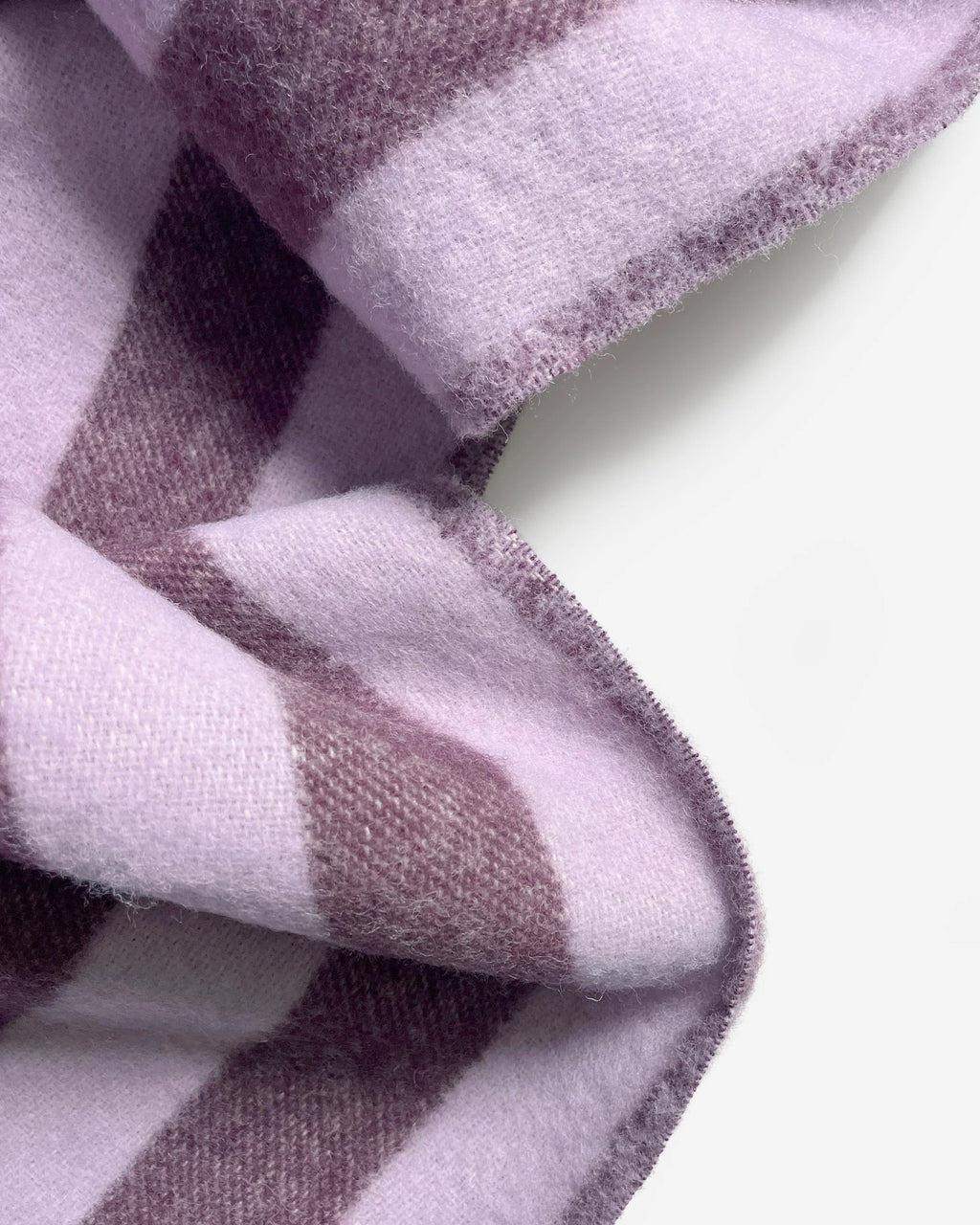 Close-up of the Maison Deux Candy Wrap wool throw in Lilac Aubergine, showing the woven stripe texture.