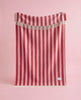 Maison Deux Candy Wrap wool throw in Pink Cherry, hanging to show the full striped pattern.
