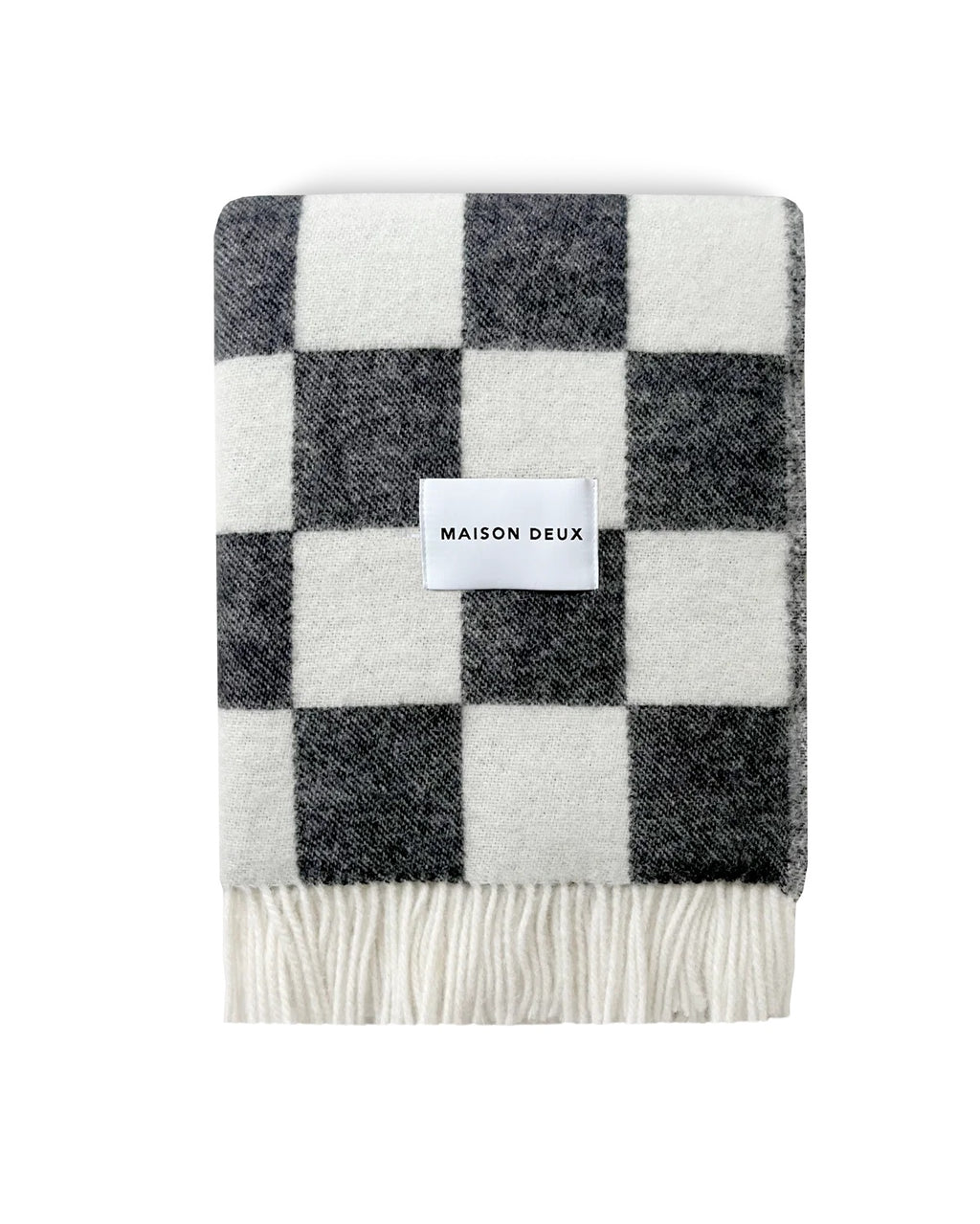 Maison Deux Checkerboard wool throw in Black White, folded with the Maison Deux label visible.