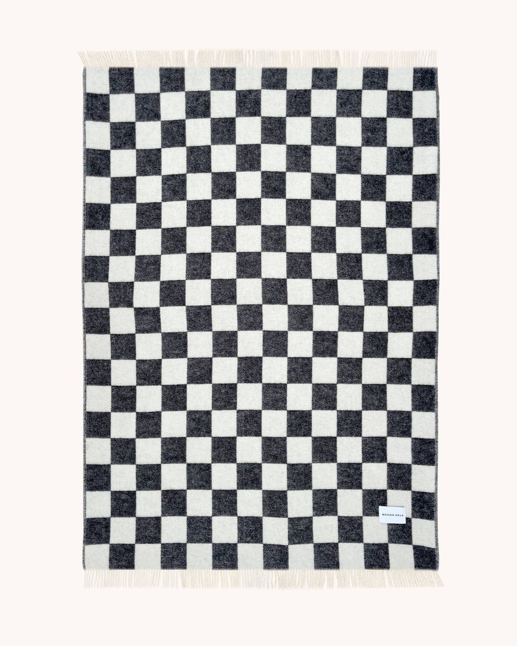 Maison Deux Checkerboard wool throw in Black White, folded flat with the full black and white pattern visible.