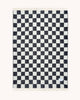 Maison Deux Checkerboard wool throw in Black White, folded flat with the full black and white pattern visible.
