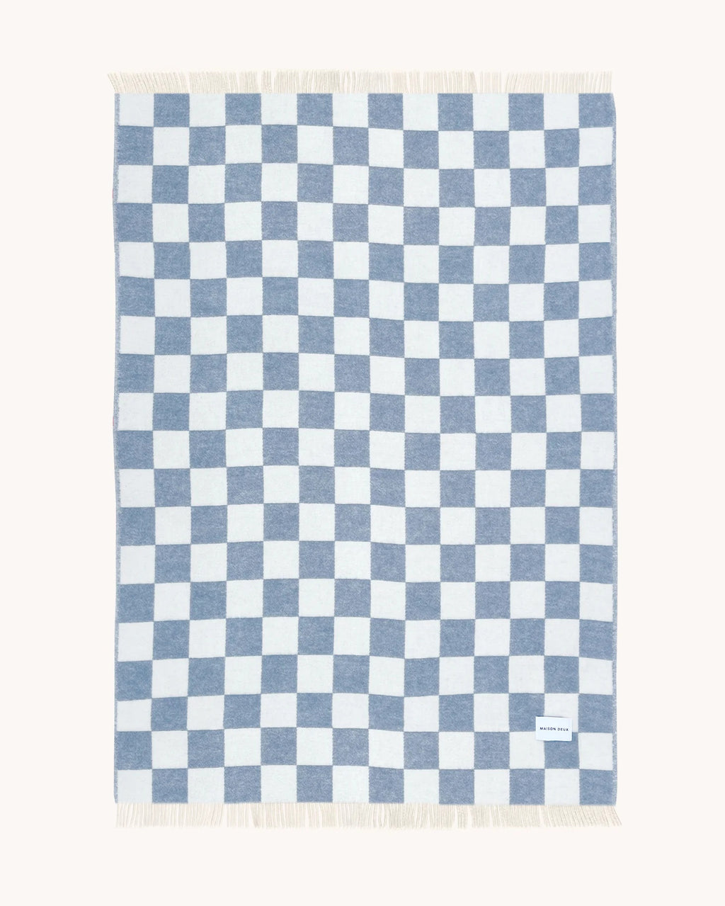 Maison Deux Checkerboard wool throw in Denim White, folded flat with the full blue and white pattern visible.