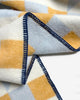 Maison Deux Cubics wool throw in Blue Honey, close up on the jacquard weave and navy blanket stitched edge