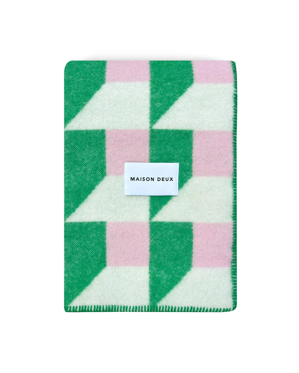 Maison Deux Cubics wool throw in Grass Pink, folded to show the cube pattern and the woven Maison Deux label