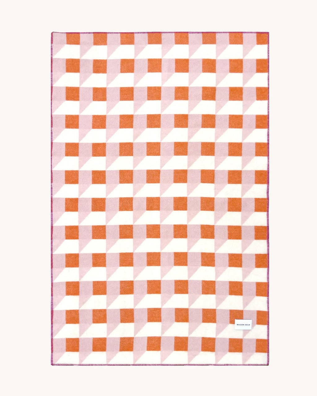 Maison Deux Cubics wool throw in Pink Carrot, spread flat to show the full pink, coral and cream cube pattern