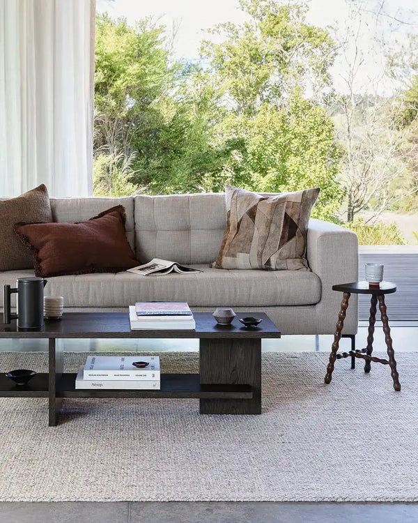 The Baya woven textural floor rug 'Omaha' in colour 'Pebble' seen in a contemporary living room