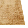 Close up view of the corner of a warm, light honey mustard brown wool blend rug by Globe West and Soren Liv NZ