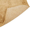 Close up view of the corner of a warm, light honey mustard brown wool blend rug by Globe West and Soren Liv NZ. The edge is flipped up to show the underside of the rug. 