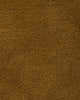 A close up of the weave of the Norfolk floor rug in Brass. The luxurious depth of the pile and sumptuous golden caramel colour make this rug a standout. 