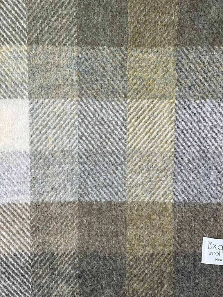 Close up of a nz wool throw blanket, by Exquisite Wool Traders, in olive green and white plaid