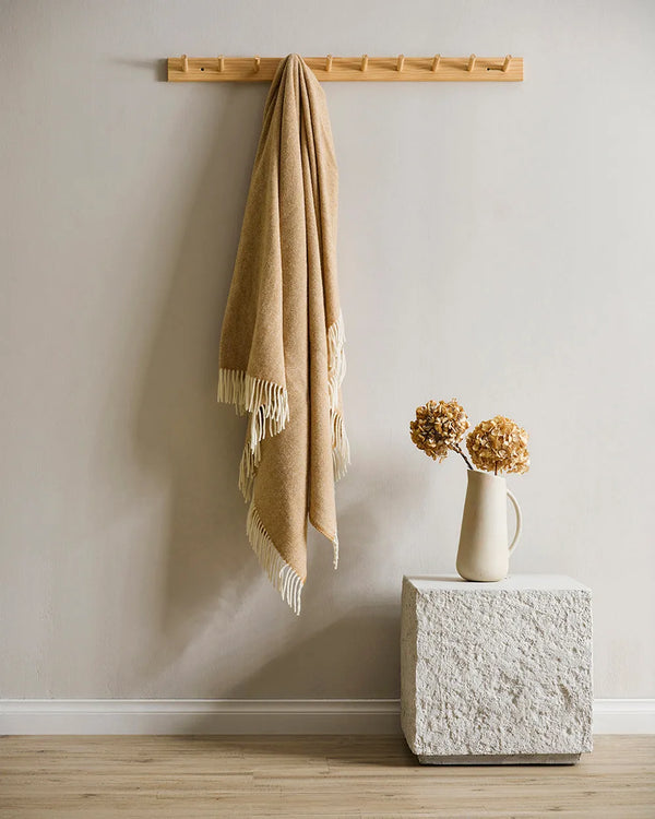 A beautiful NZ made throw blanket in 100% NZ wool, featuring a twill weave and trending ochre colour
