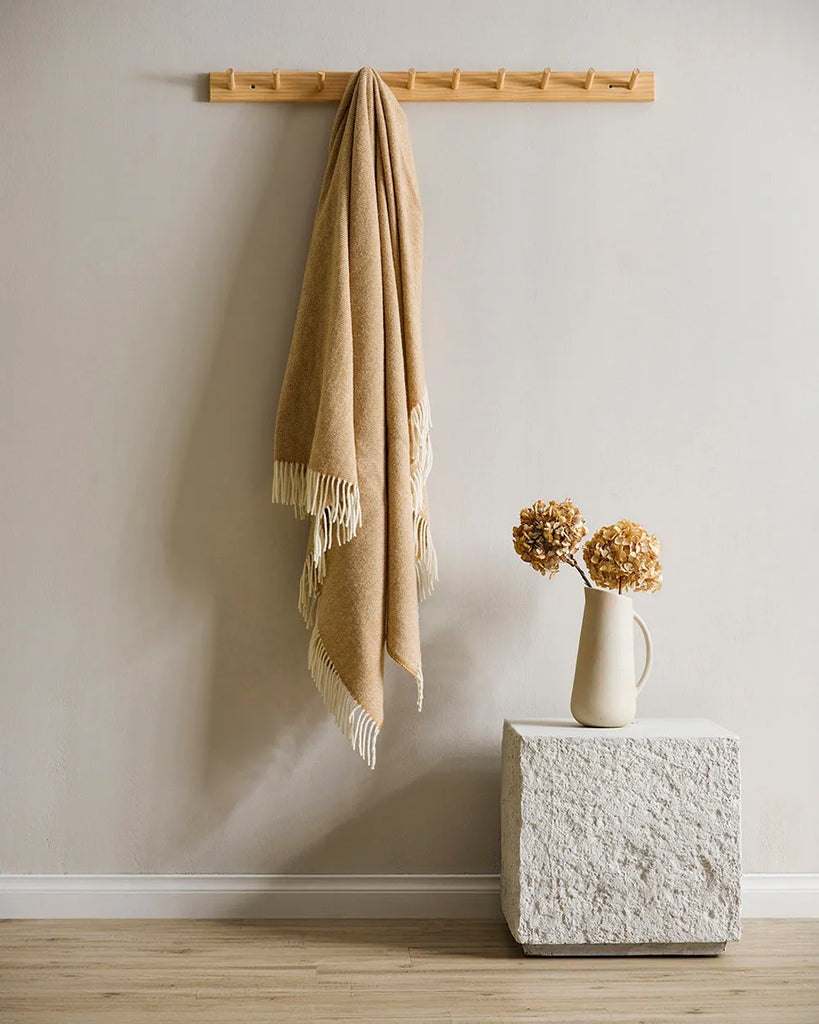 A beautiful NZ made throw blanket in 100% NZ wool, featuring a twill weave and trending ochre colour